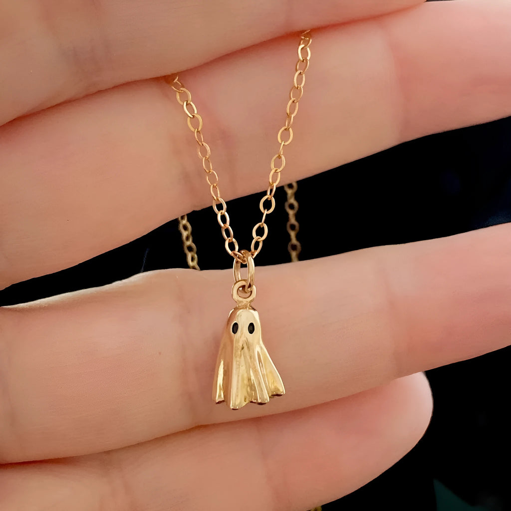 A ghost pendant necklace on a twisted stainless steel chain, showing the titanium steel electroplated pendant.