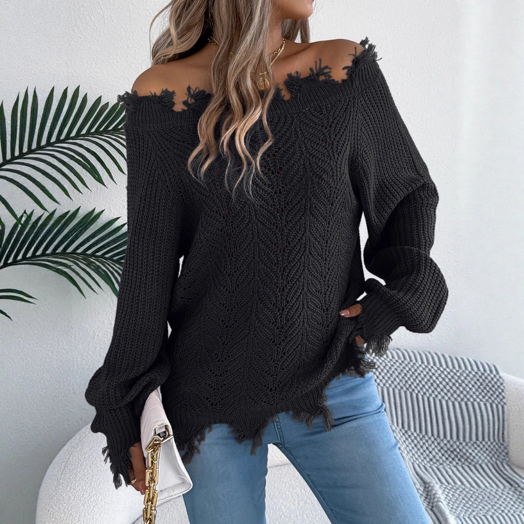 White hollow-out patterned long-sleeved sweater with a cut off-the-shoulder neckline on a model.