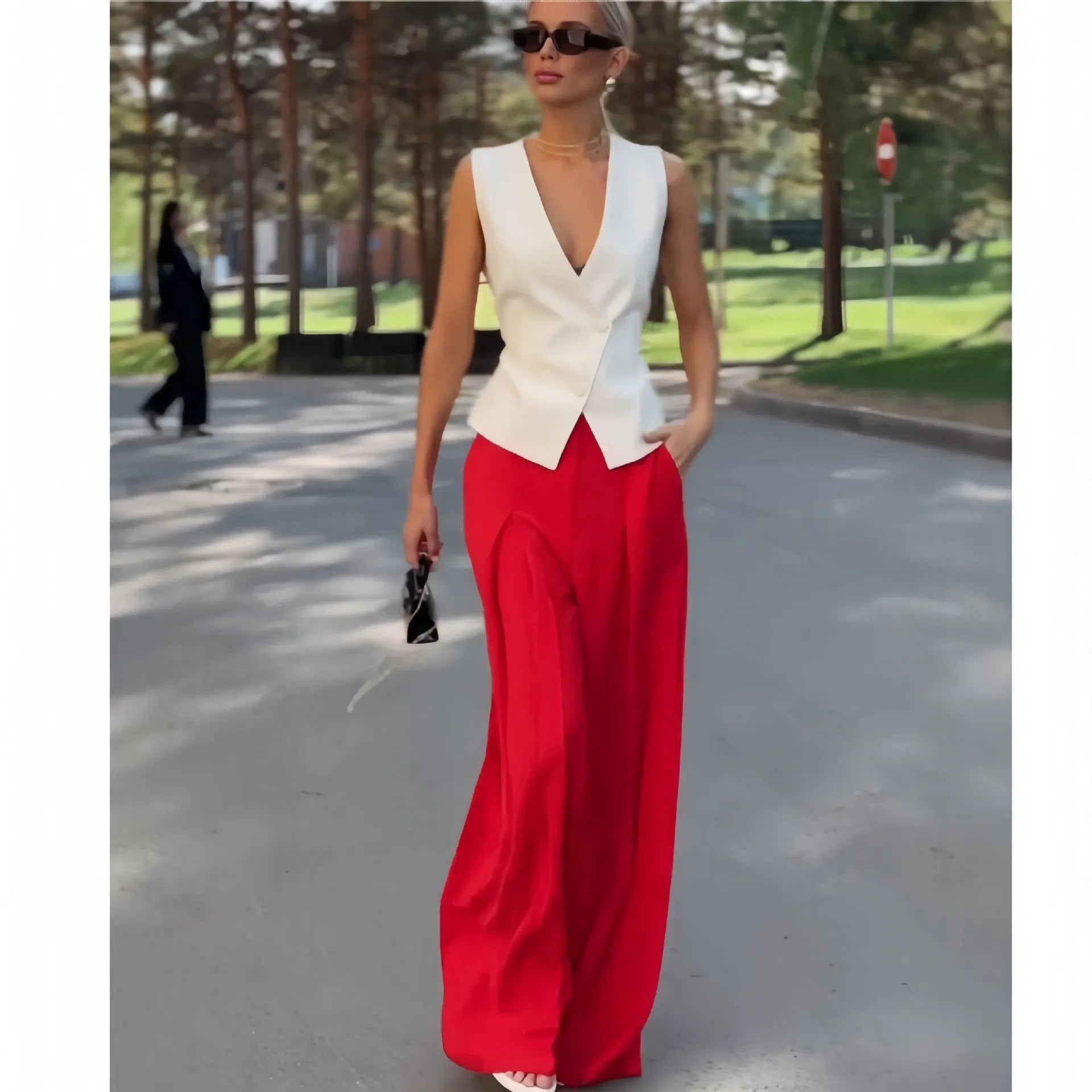 Women's beige two-piece set with deep V-neck sleeveless top and wide leg trousers