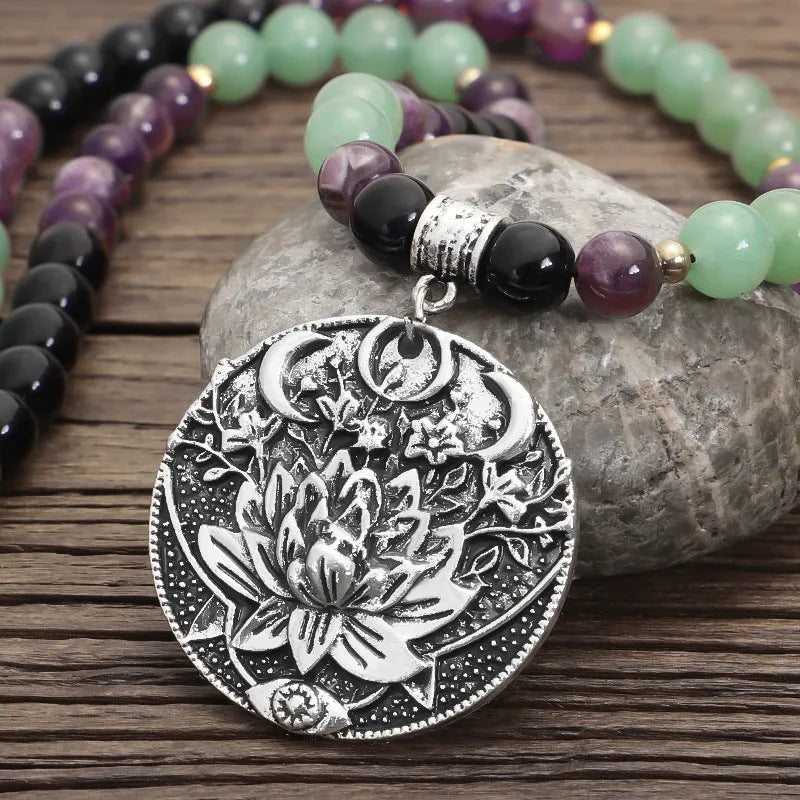 Handmade yoga necklace with lotus pendant and stone beads alongside matching bracelet
