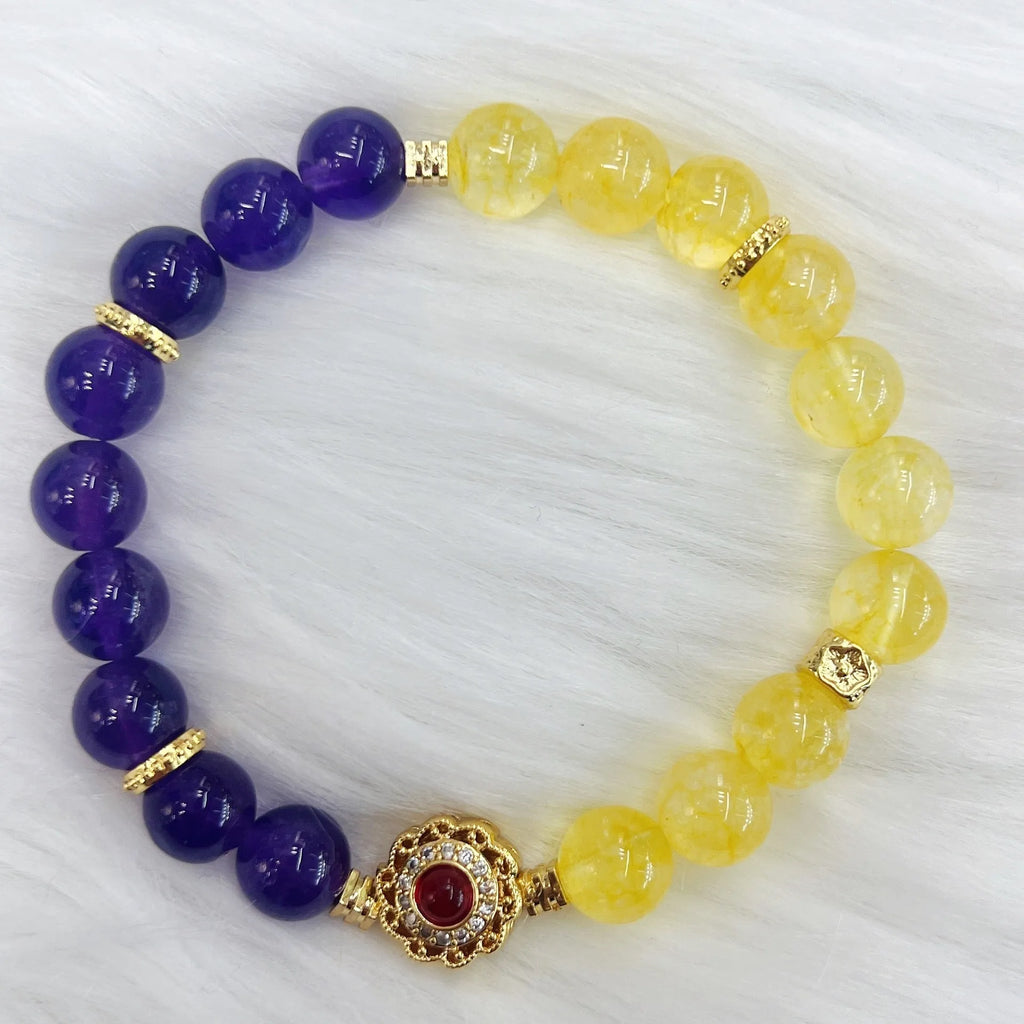 Handmade yellow and purple crystal bracelet for women on a wrist.