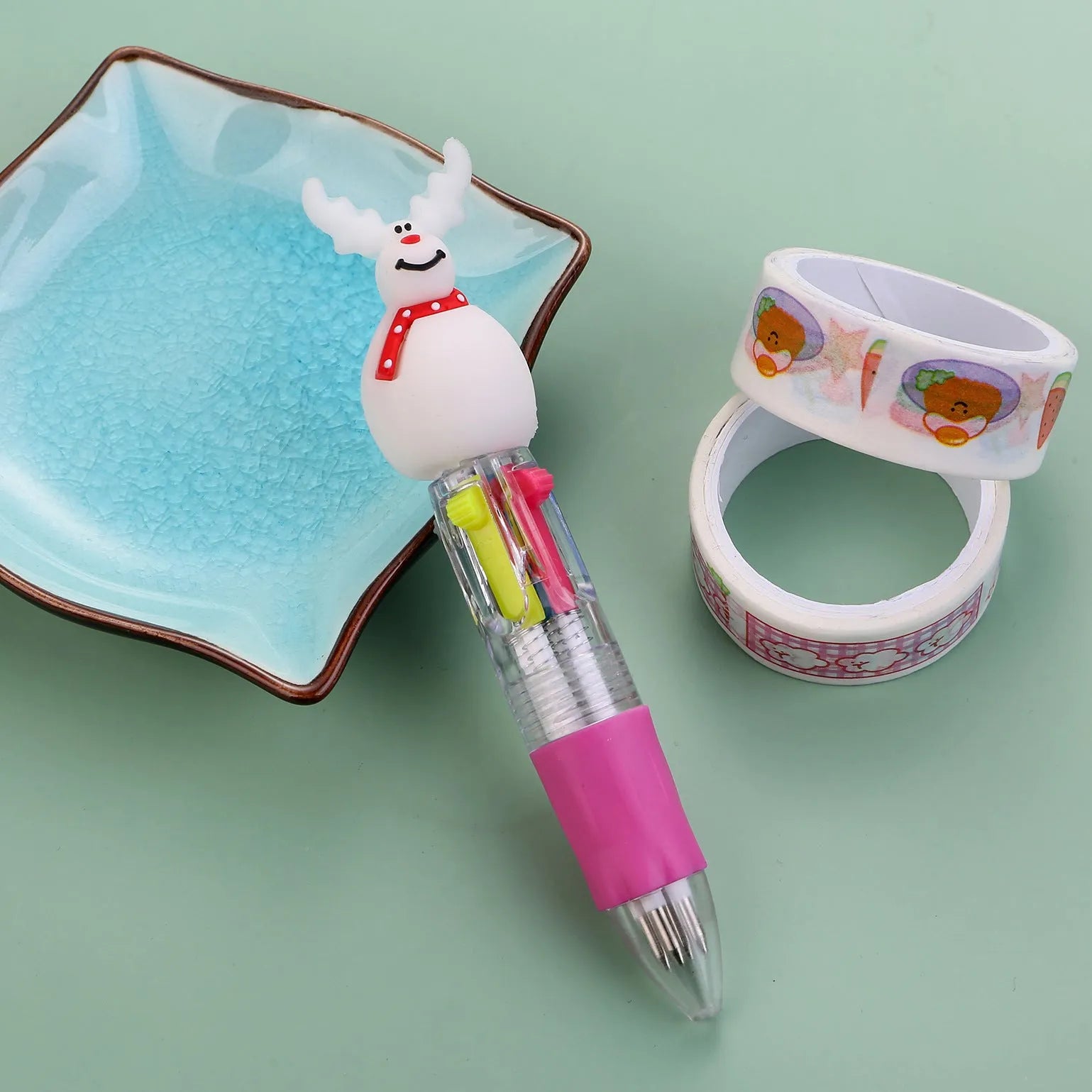 Christmas mini four-colour press-action ballpoint pen with festive designs measuring 11 cm.