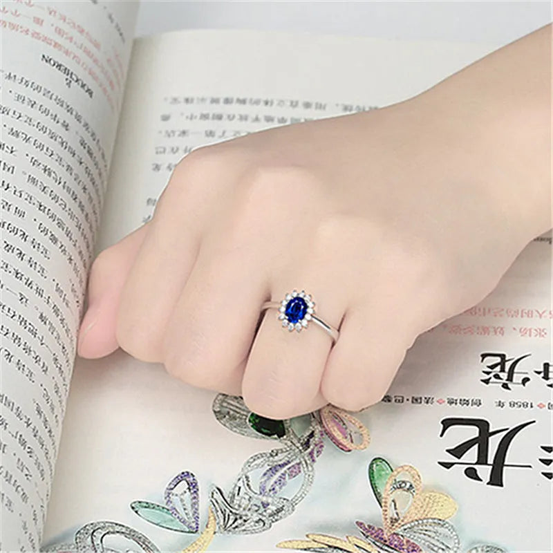 Gold ring with high-grade blue zircon gemstone round cut on white background