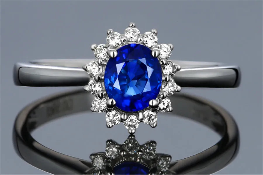 Gold ring with high-grade blue zircon gemstone round cut on white background