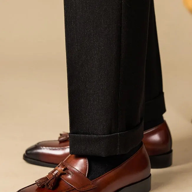 Men's leather tassel loafers in black and brown with polished finish and rubber soles