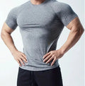 Men's black short sleeve casual T-shirt made from quick-dry polyester fabric on a hanger.