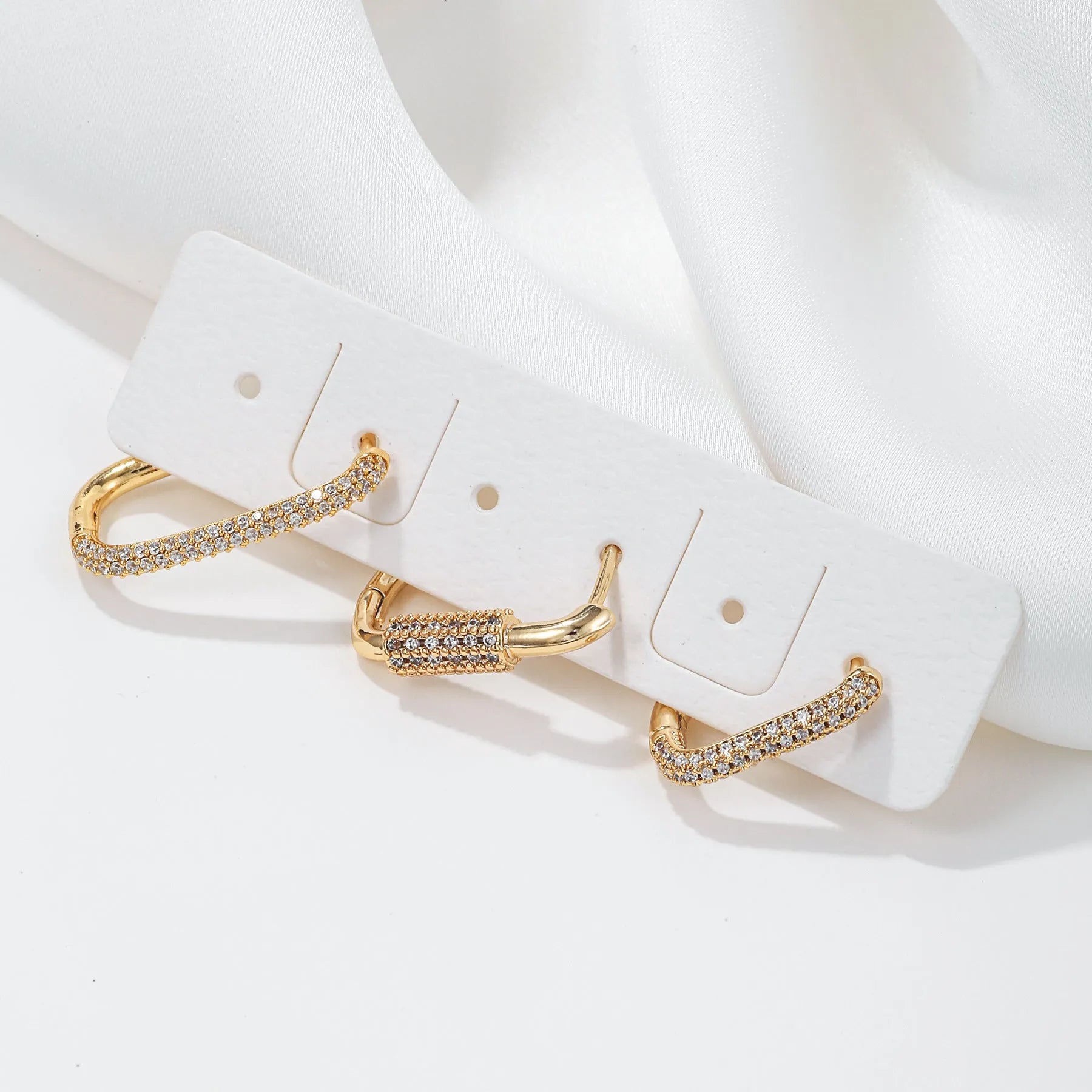 Three geometric square ear clips with inlaid zircon stones in gold and white colour options
