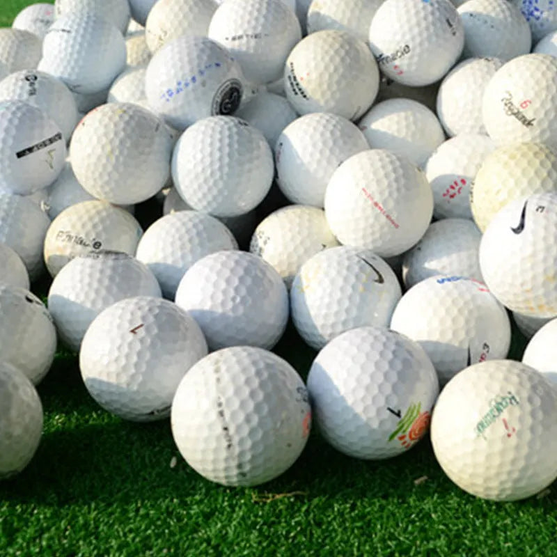 White Golf Next practice game ball with 352 beehive dimples on grass