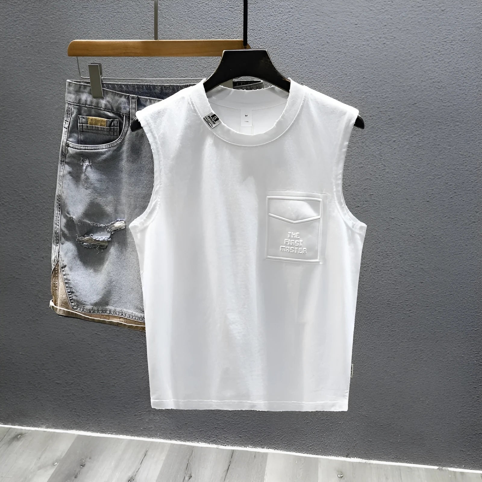 A man's solid colour loose-fit cotton sleeveless t-shirt with a straight hem.