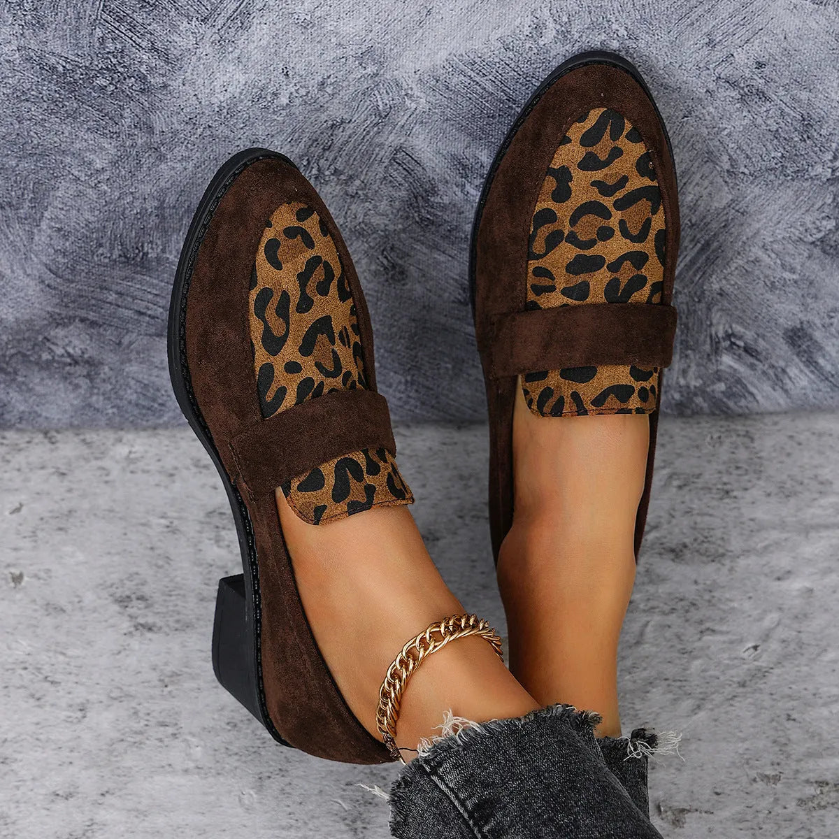 Leopard print suede slip-on shoes with a chunky mid heel and pointed toe on a rubber sole