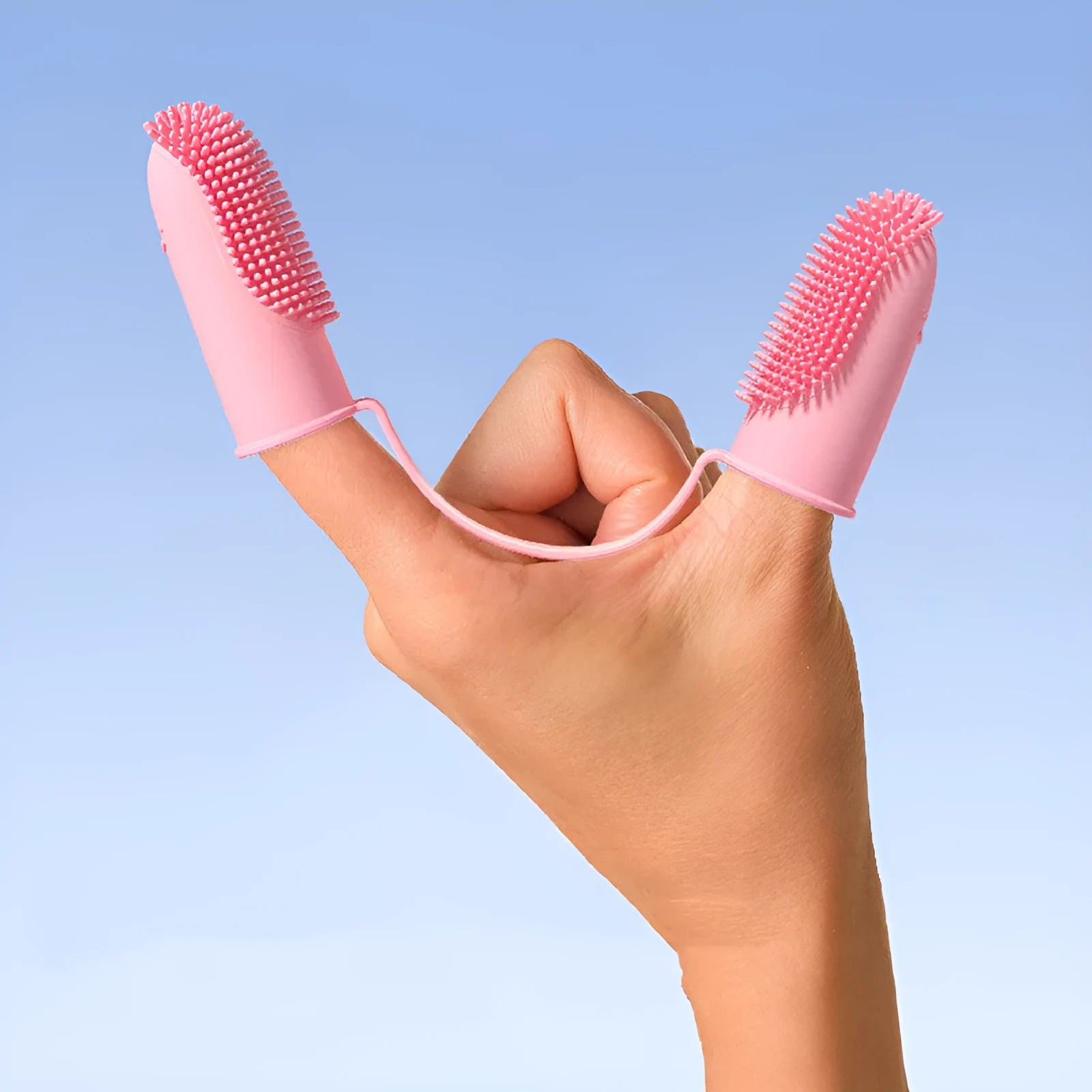 TPR pet dental finger brush in blue green, pink, or yellow for cleaning teeth and gums.