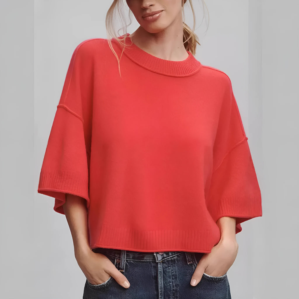 Red cropped t-shirt on a hanger, showing midriff length and regular sleeves.