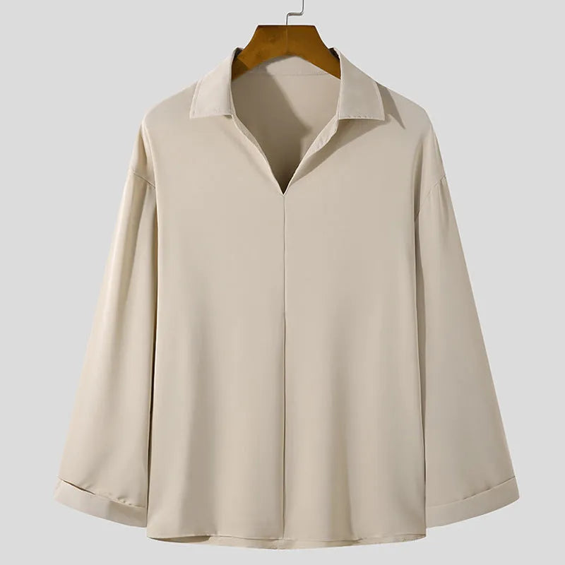 Man wearing a loose fit lapel collar casual shirt in a solid colour.