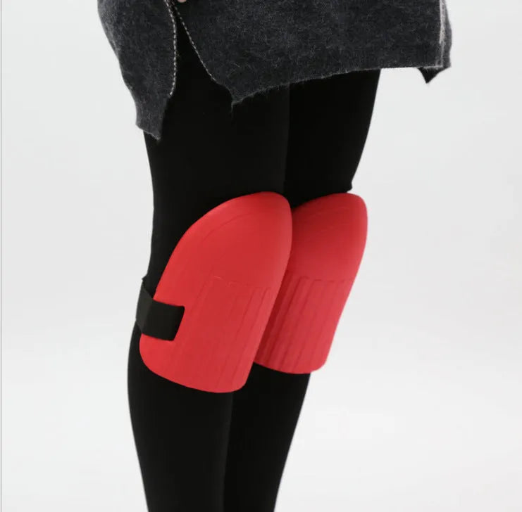 A pair of thick black EVA foam knee pads for garden kneeling, showing size and cushioning.