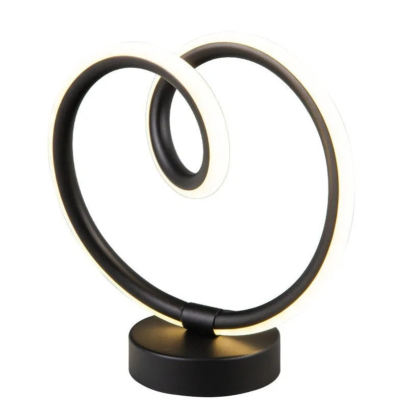 Black musical note-shaped Bluetooth LED light with app remote control on a bedside table.