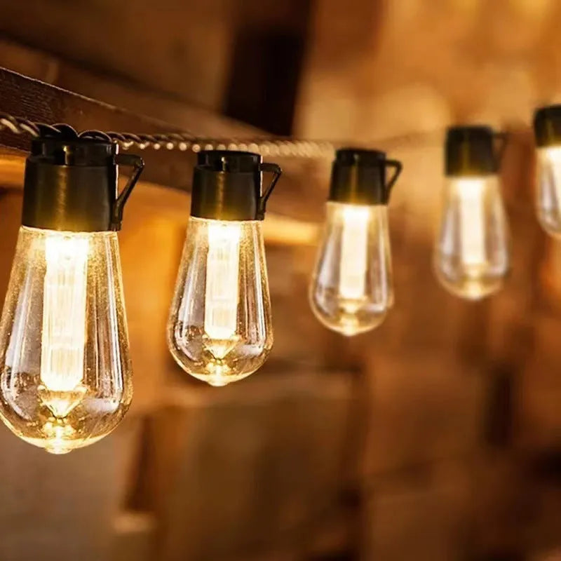 Retro outdoor string lights with infusion bottle-shaped bulbs in garden setting