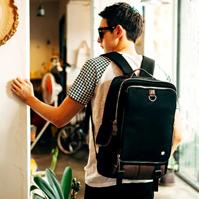 Large grey Korean-style backpack made of Oxford cloth, shown next to a laptop for scale.