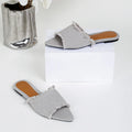 Women's denim flat slippers with a tassel, leather lining, and a lightweight PVC sole.