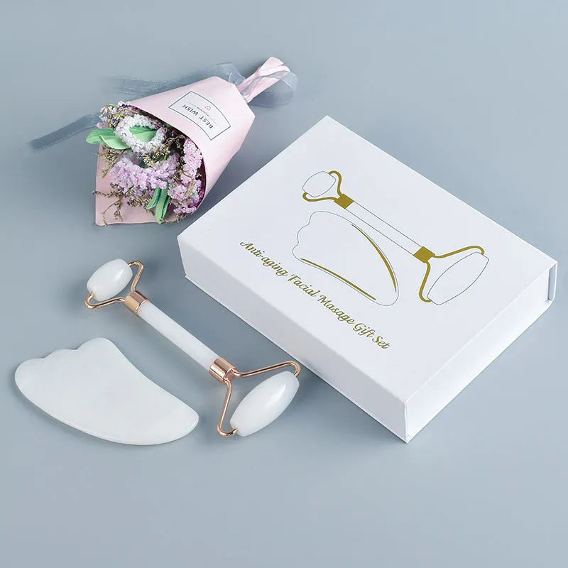 White jade dual-head facial roller and gua sha tool with a separate massage board on a plain background.