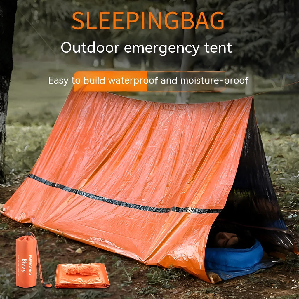Portable orange disaster relief tent with sleeping bag and emergency blanket setup outdoors