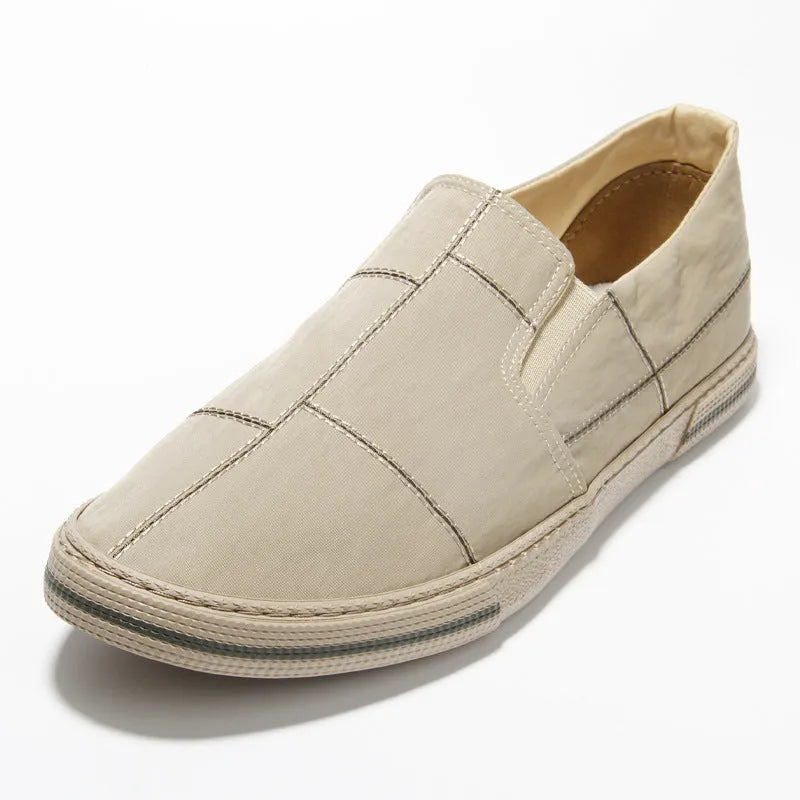 Men's slip-on canvas low-top shoes in all black with round toe and rubber sole