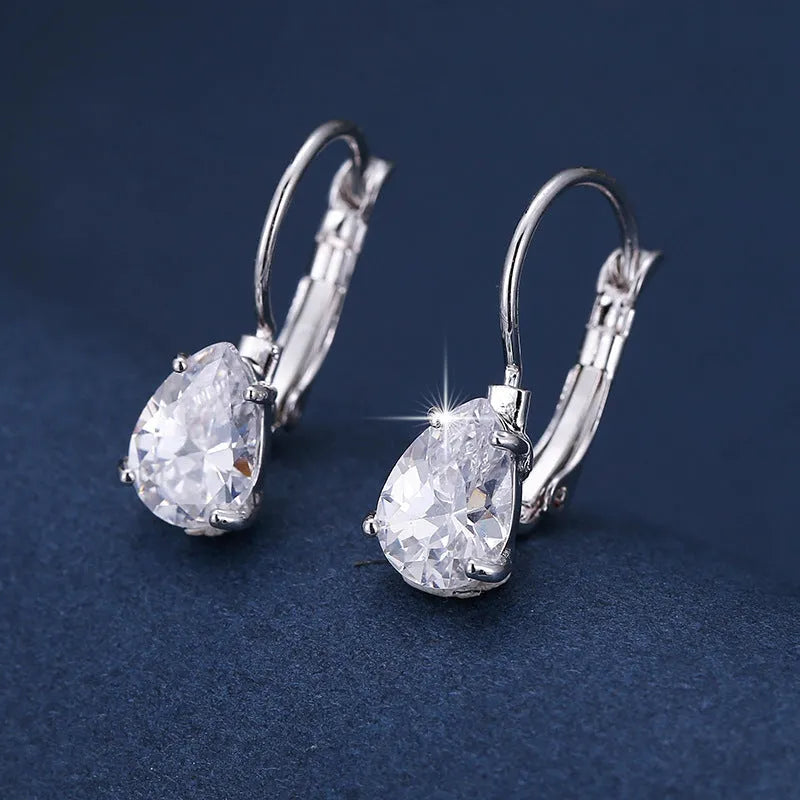 Drop-shaped women's metal earrings with gemstones in gold or platinum colour.