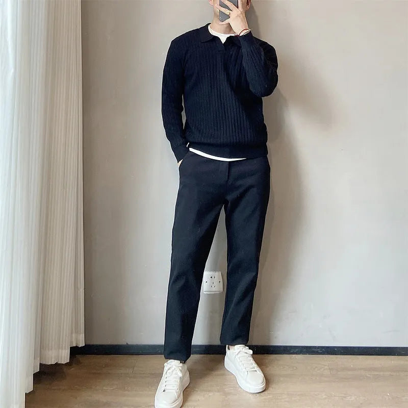 Man wearing a loose fit, textured grey knitted sweater with long sleeves for casual autumn wear.