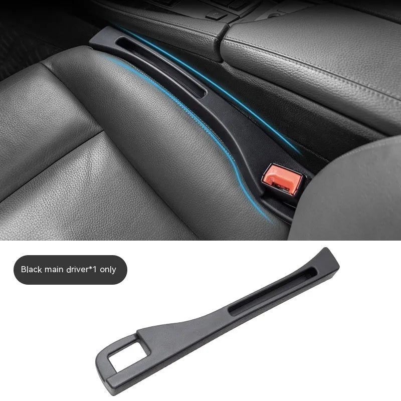 Black plastic car seat gap storage box with handle positioned between vehicle seats