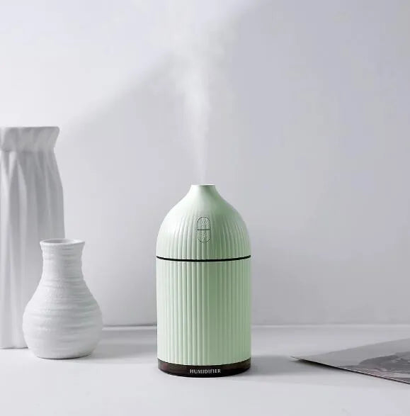 White ultrasonic aromatherapy diffuser with 300ml capacity, USB port, and LED light on wooden surface
