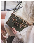 Black hard PU leather women's shoulder bag with flap, hasp closure, and rivet decoration.