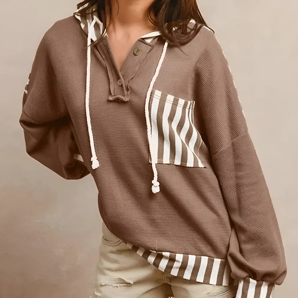Straw yellow waffle texture hoodie with striped patchwork panels and a button neck.