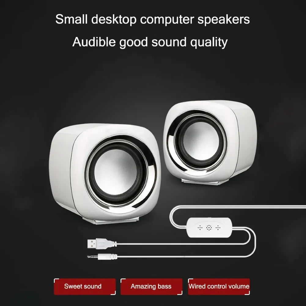 Pair of small black wired desktop computer speakers with volume wheel