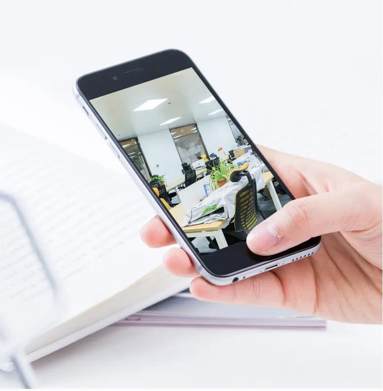 White indoor security camera with 360-degree rotation on stand showing WiFi connectivity