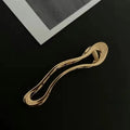 Women's zinc alloy barrettes in gold and silver finishes showing square, arc, and triangle shapes