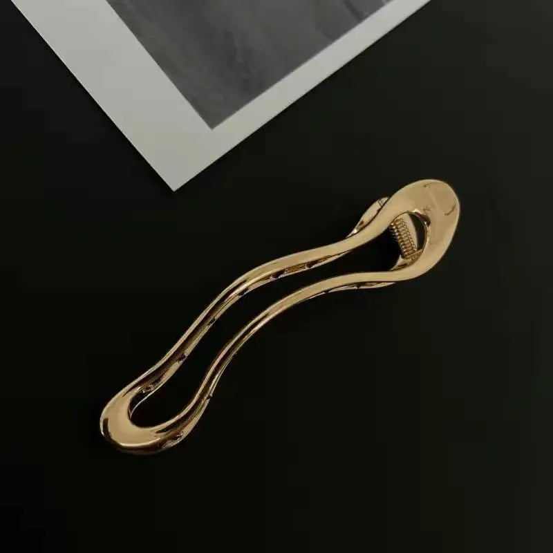 Women's zinc alloy barrettes in gold and silver finishes showing square, arc, and triangle shapes