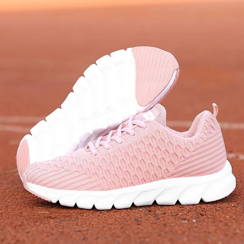 Women's running shoes with fly weave upper in black, pink, or white, showing wear-resistant outsole.