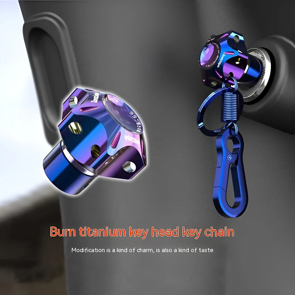 Close-up of aluminium motorcycle key head covers showing hexagonal, five-pointed star, and plum blossom designs with blue and white key chains.
