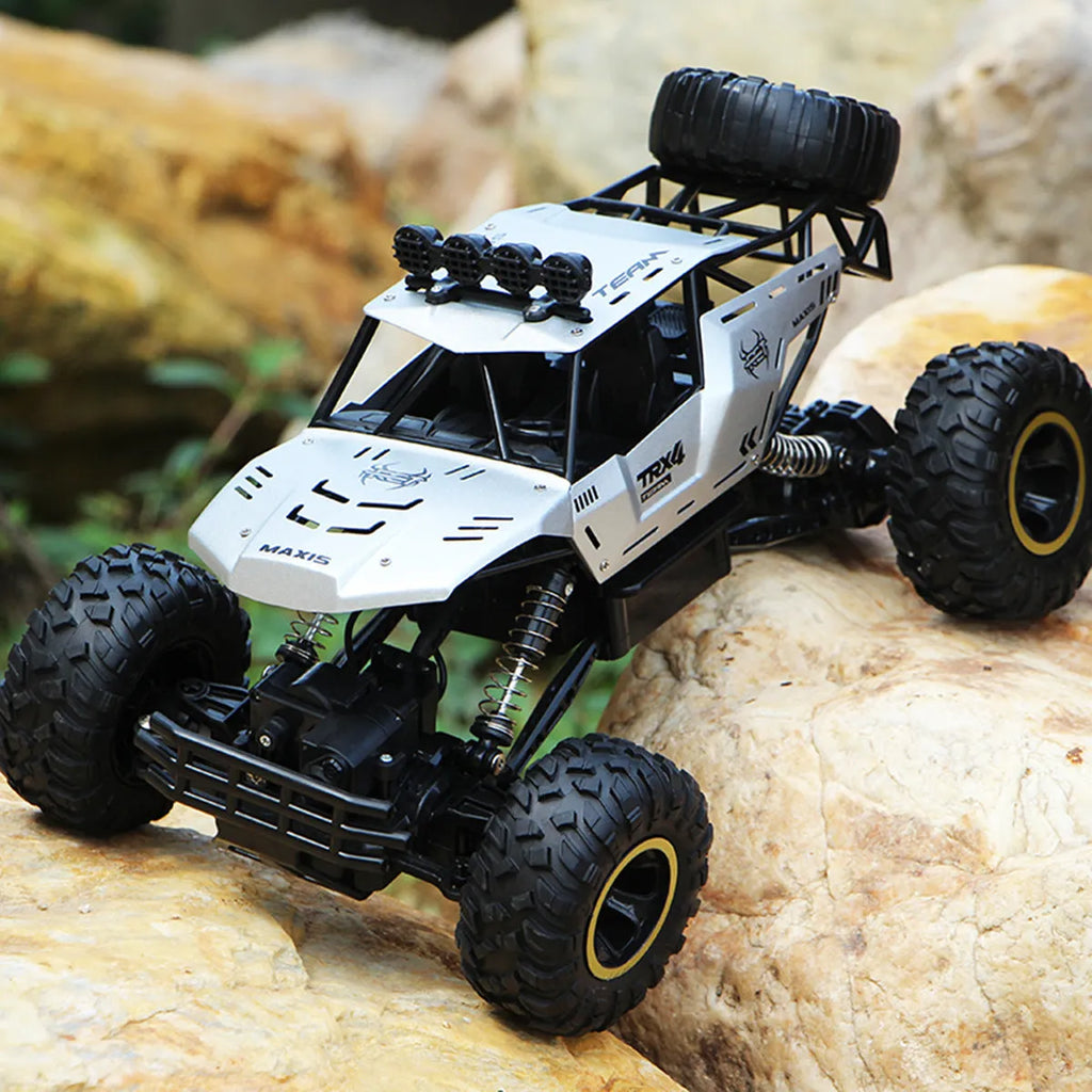 Large black 4WD remote control climbing car on rough terrain with wireless controller