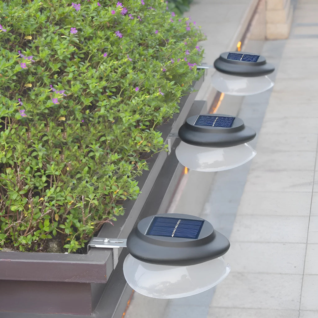 Solar outdoor wall lamp in black or white plastic housing with integrated solar panel and 9 LEDs.