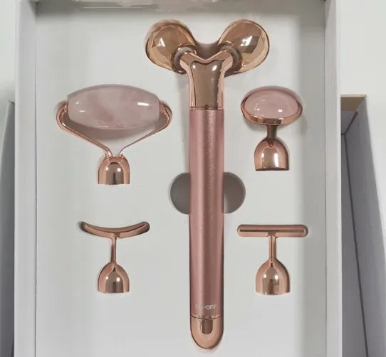 Rose gold five-in-one vibrating face lifting machine with four interchangeable jade and beauty heads in a compact box