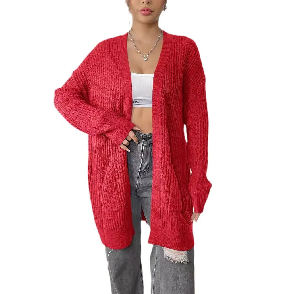 Women's dark green loose fit acrylic cardigan sweater with double pockets and long sleeves.