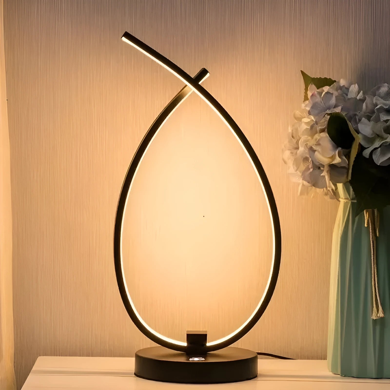 Black and white water drop shaped USB bedside lamp with touch and switch control.