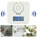 White wireless carbon monoxide alarm mounted on a wall for home safety.