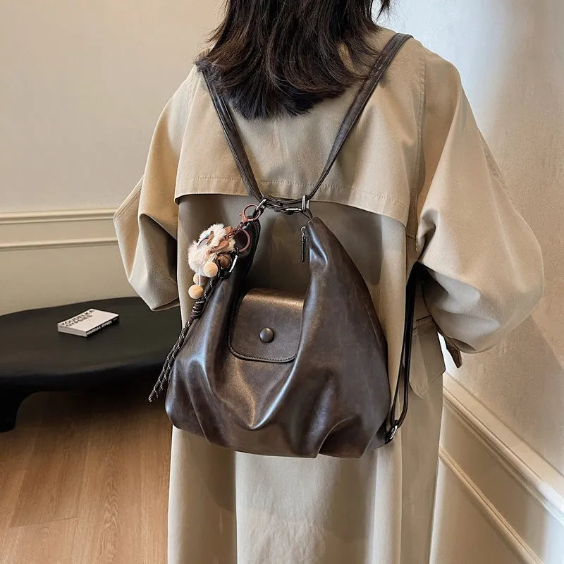 Textured PU leather commuter backpack with single shoulder strap and internal mobile phone pocket