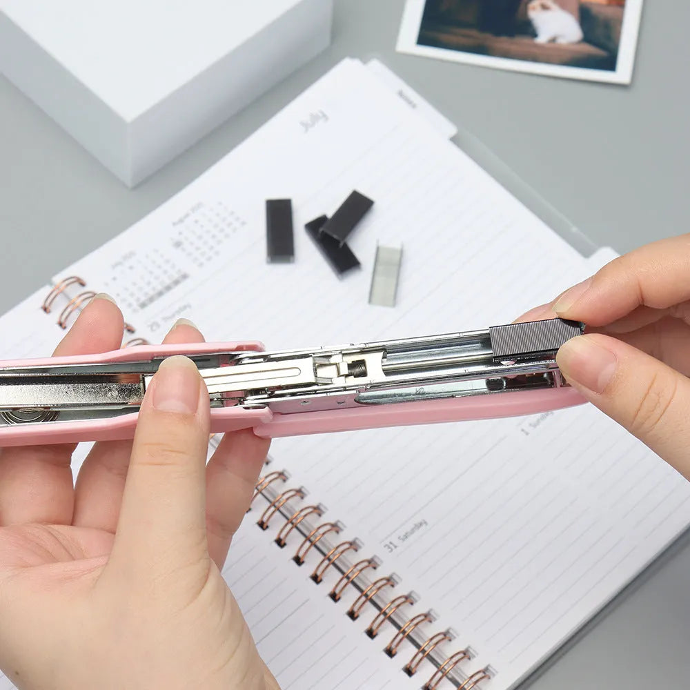 A box of 1000 metal office staples in rose gold, black, purple, and rose red colour options.