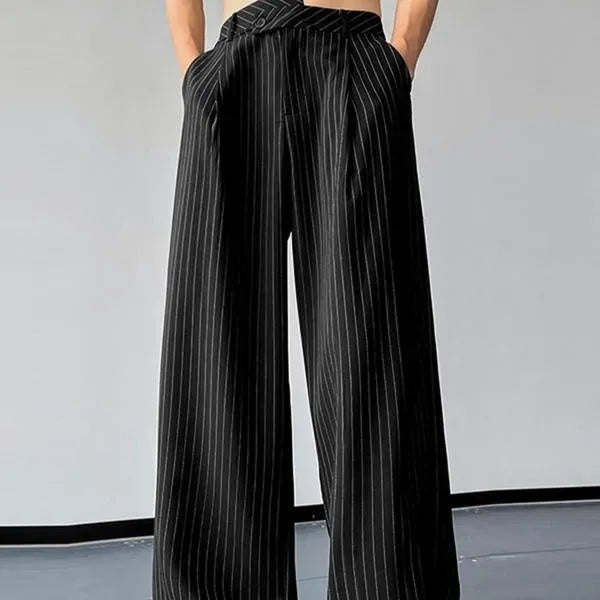 Man wearing black vertical stripe pleated casual trousers.