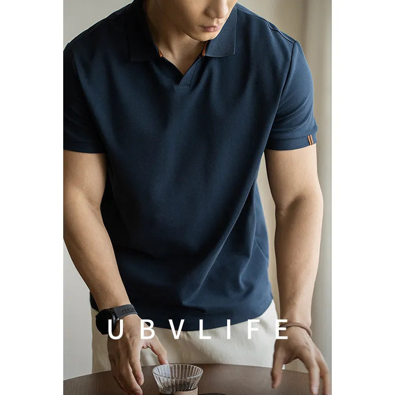 Men's blue cotton blend short-sleeve polo shirt on a hanger, showing the collar and regular fit.