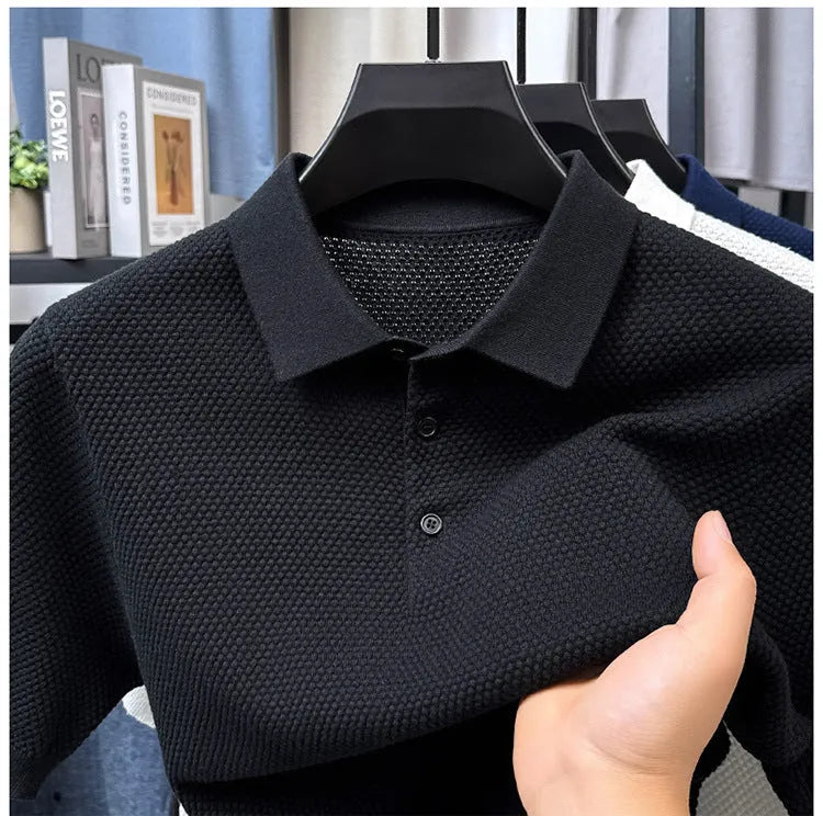 Man wearing a loose-fit grey short sleeve cotton pullover sweater for casual leisure wear.