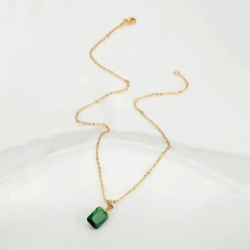 Rectangular geometric copper necklace with quadrilateral design on green background