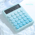 Gradient colour desk calculator in violet, cherry blossom pink, blue, or mint green on a desk.